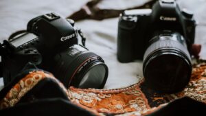 Close-up shot of two high-end DSLR cameras with lenses, ideal for photography professionals.