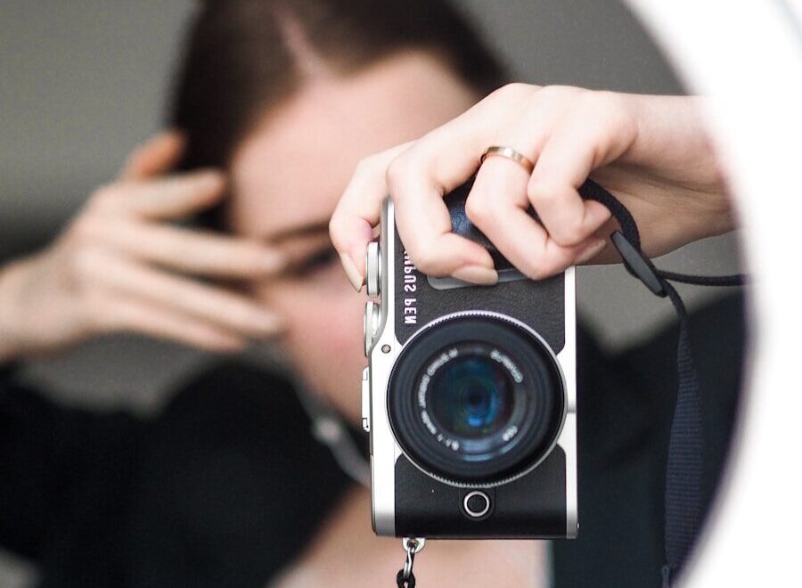 person holding black and silver camera